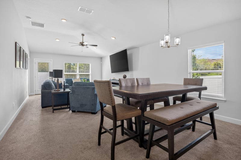 Open living and dining area with ceiling fan at 9846 Olivia St, Jacksonville, FL