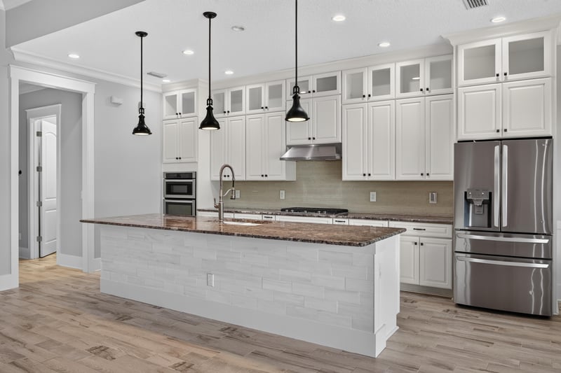Kitchen with stainless refrigerator and island seating at 186 Freshwater Dr