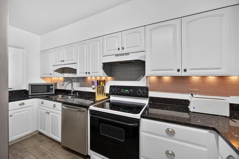 Kitchen with white cabinets and stainless range at 601 1st St S, Jacksonville Beach