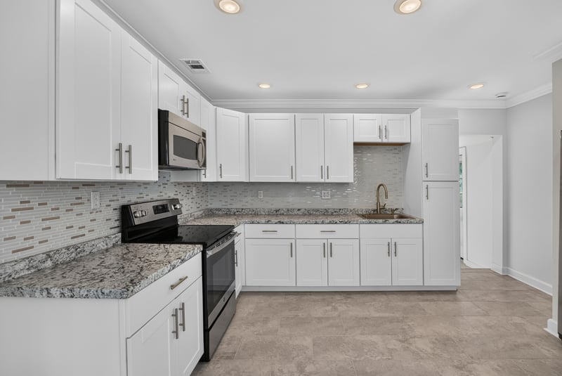 Kitchen with white cabinets and black range at 316 W 41st St, Jacksonville, FL 32206