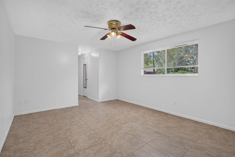 Bedroom with ceiling fan and window at 9954 Larkdale Ct, Jacksonville, FL 32257