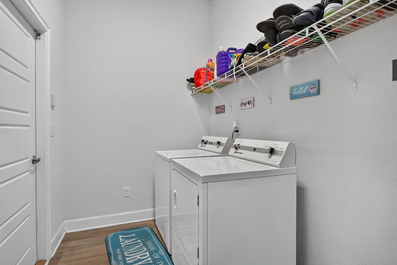 Bedroom with wall-mounted TV and media console at 9846 Olivia St, Jacksonville, FL