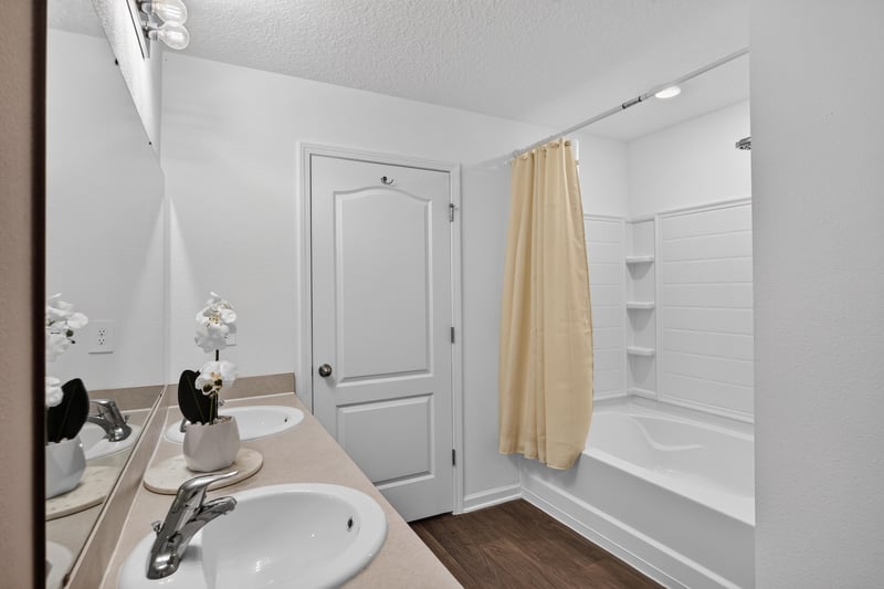 Bathroom mirror and vanity with tan accents at 65255 Frst Glen Ln, Yulee, FL 32097