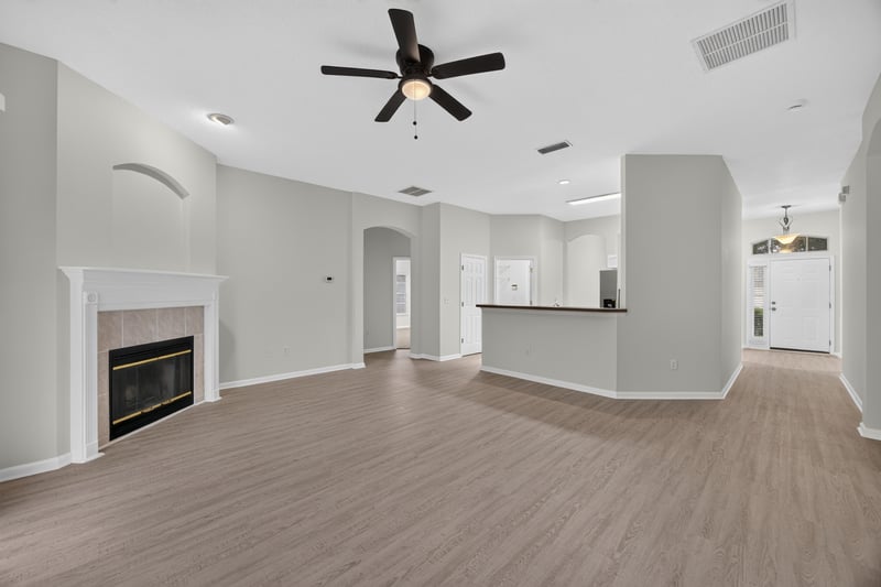 Open living area with fireplace and kitchen island at 706 Bonaparte Dr, Jacksonville, FL 32218