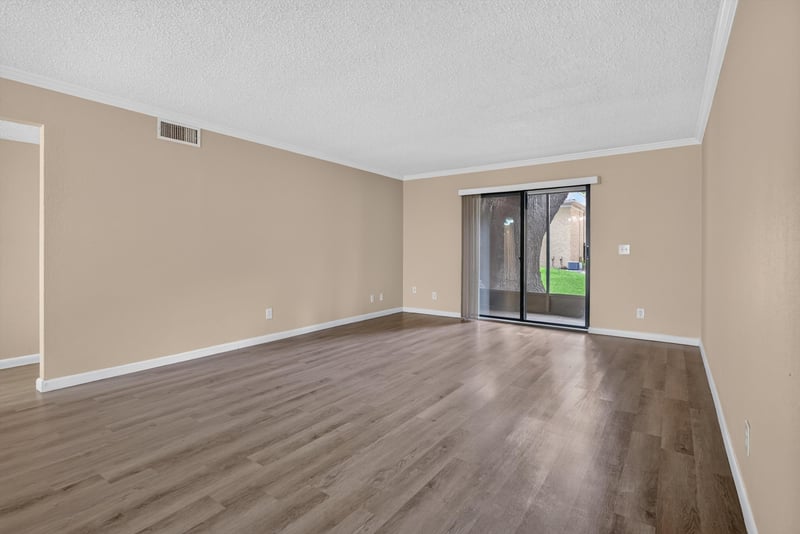 Empty living room with sliding glass door at 5811 Atlantic Blvd unit 47, Jacksonville, FL 32207