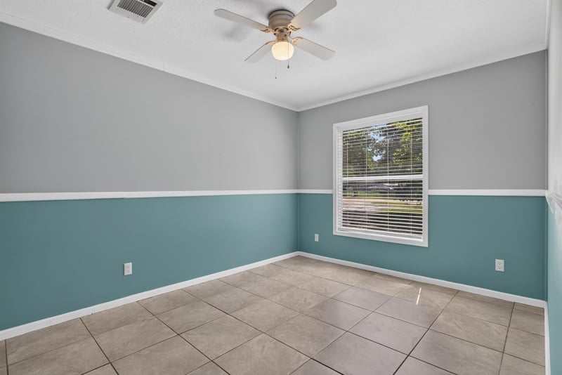 Empty bedroom with teal and gray walls at 2549 Snapdragon Ave, Middleburg, FL 32068