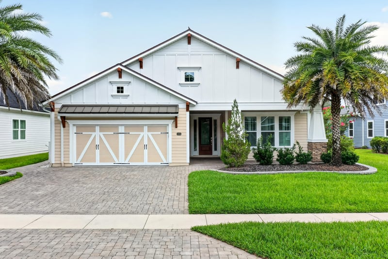 Front exterior with paver driveway and three-car garage at 186 Freshwater Dr