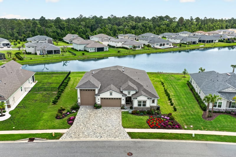 Drone view of the home's street and pond in Fernandina Beach, FL