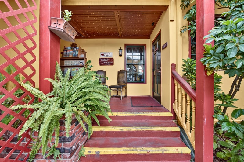 Side porch with lattice trim and potted plants at 115 Cordova St, St. Augustine, FL