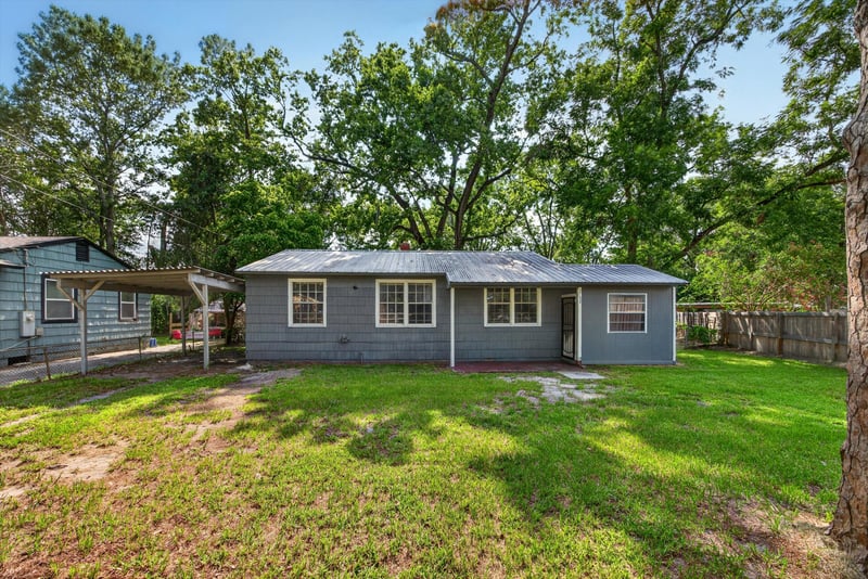 Front exterior with carport and trees at 2132 Allandale Cir W, Jacksonville, FL