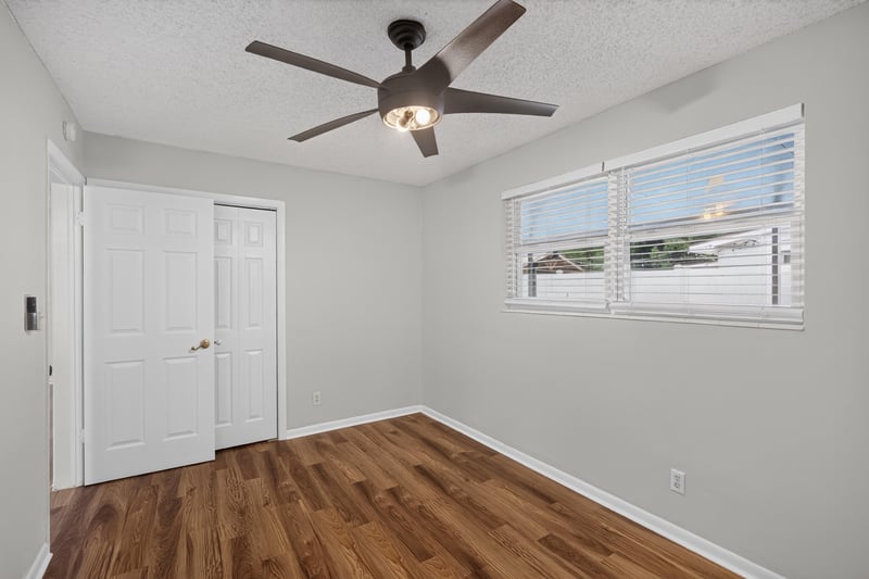 Bedroom with closet doors, window and ceiling fan at 4039 Habana Ave, Jacksonville, FL
