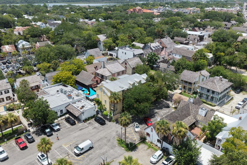 Aerial view of tree-lined streets and rooftops near the property at 29 Cuna St, St. Augustine, FL 32084