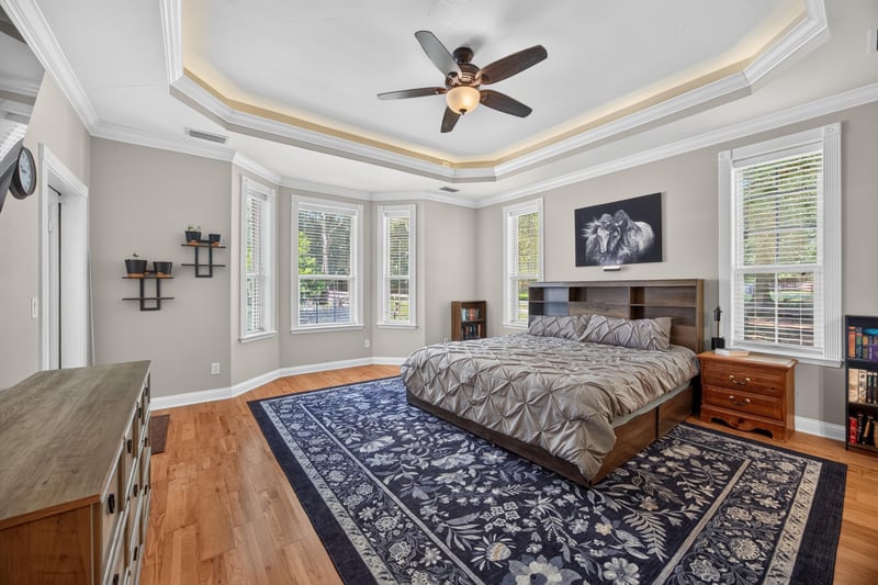 Primary bedroom furnished with gray bedding at 1735 Hagans Ridge Ct