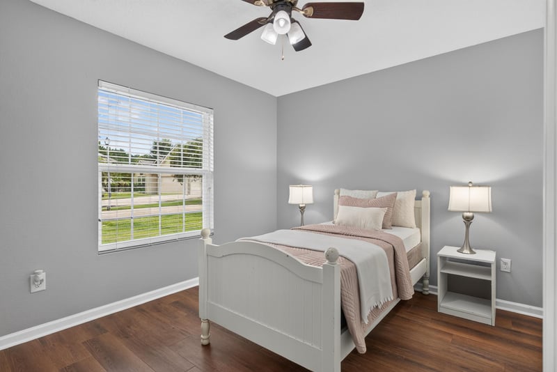 Bedroom with staged bed at 706 Grampian Highlands Dr, St. Johns, FL 32259