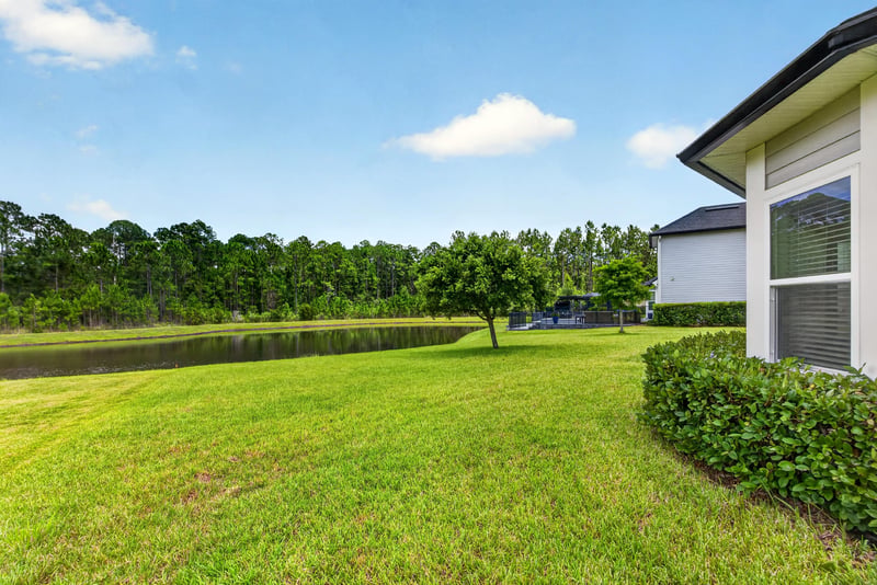 Backyard view of lawn and pond at 53 Lumen Ct, St. Augustine, FL 32095