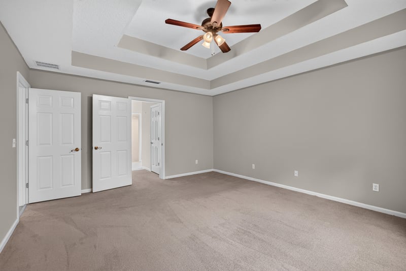 Empty bedroom with tray ceiling at 1955 GUARDED Way, Fleming Island, FL 32003