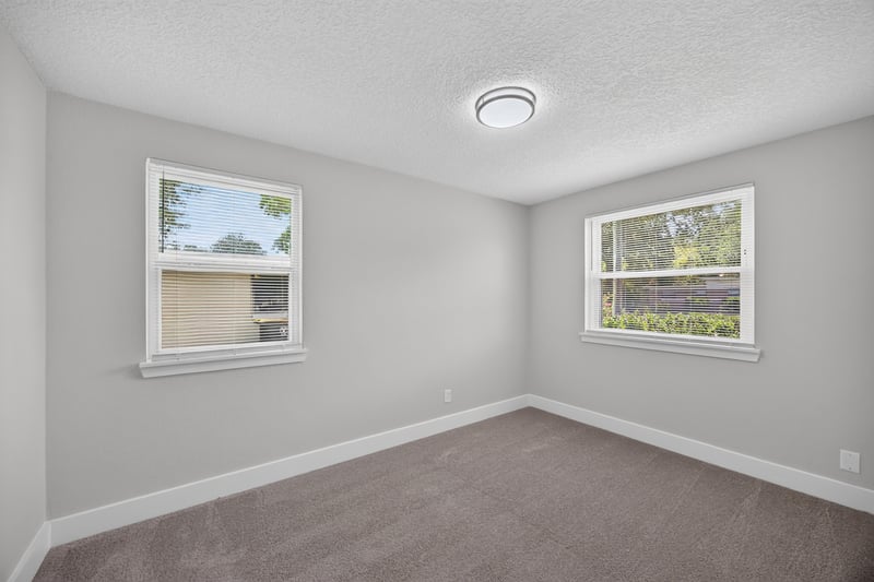 Bedroom corner with carpet and windows at 6238 Randia Dr, Jacksonville, FL 32210