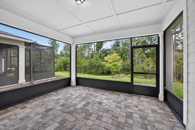 Screened porch with paver flooring at 171 Oyster Shell Ter, Nocatee, FL 32081