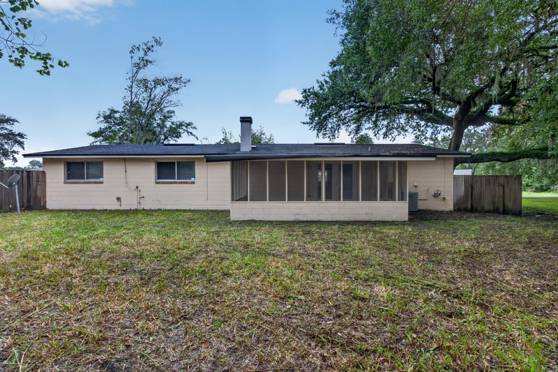 Rear exterior with screened porch and lawn at 1435 Undine Ave, Jacksonville, FL