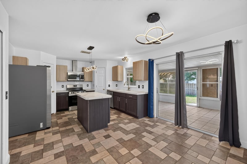 Kitchen with island, dark cabinets and stainless appliances at 3428 Glenn Hollow Ct, Jacksonville, FL 32226