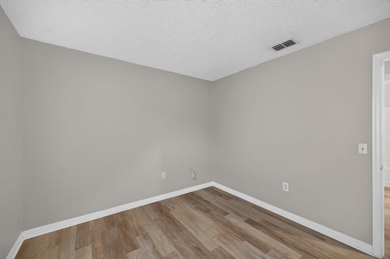 Empty room with wood-look flooring at 1845 Saga Ct, Middleburg, FL