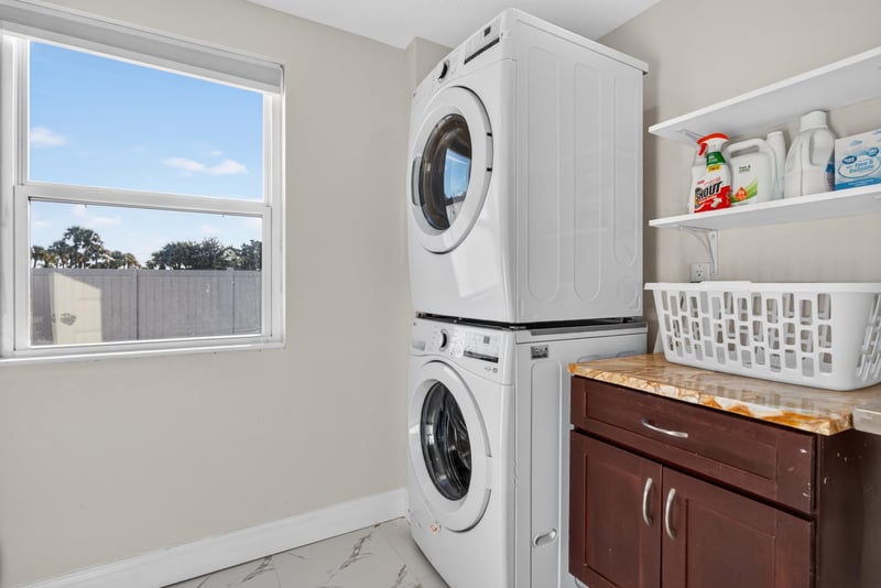 Laundry closet with stacked washer and dryer at 1525 8th St N, Jacksonville Beach, FL
