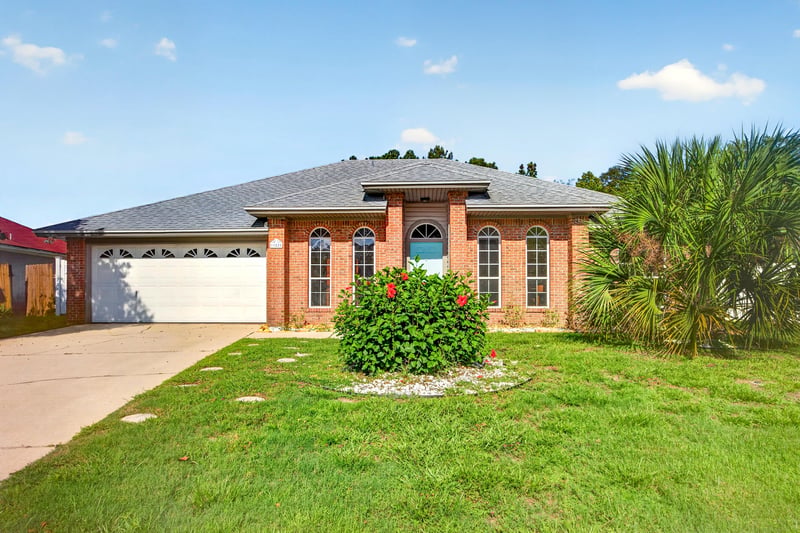 Front exterior with brick facade and landscaping at 11828 Heather Grove Ln, Jacksonville, FL