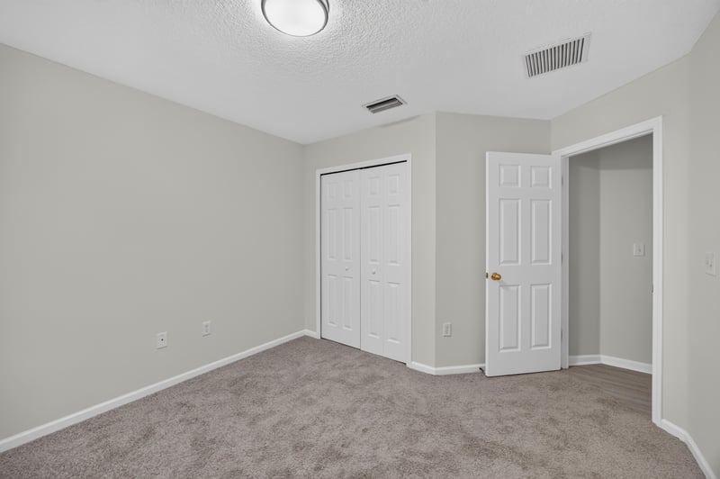 Empty carpeted room at 706 Bonaparte Dr, Jacksonville, FL 32218
