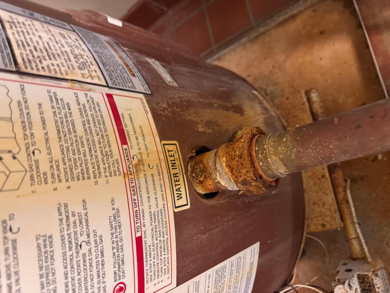 Corroded water heater connections and warning label at 11700 New Kings Rd, Jacksonville, FL 32219