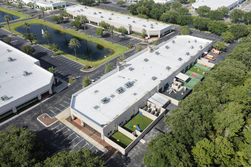 Aerial view of a building roof with pond at 10550 Deerwood Park Blvd, Jacksonville, FL 32256