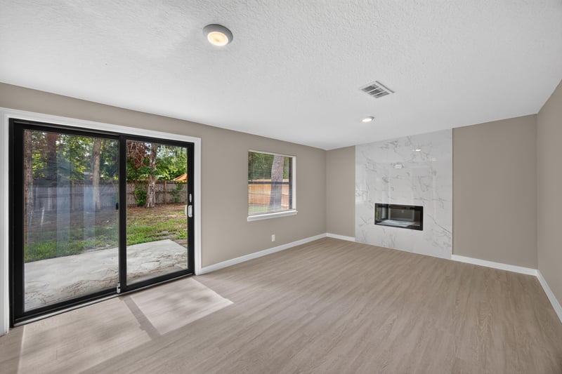 Empty living room with sliding glass doors to backyard at 184 Draco St, Orange Park, FL 32073