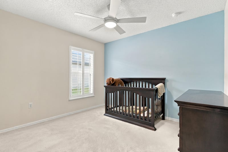 Bedroom used as nursery with blue accent wall at 11197 Illford Dr