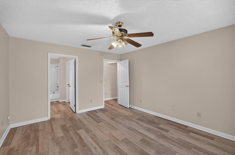 Hallway with multiple doors and wood-look floors at 6646 Shiloh Creek Dr