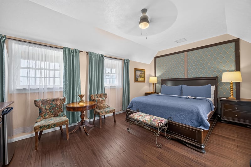 Bedroom with blue bedding and green curtains at 115 Cordova St, St. Augustine, FL