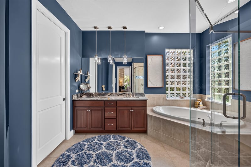 Primary bathroom with dual vanity and soaking tub at 140 Ave De La Mer, Palm Coast, FL 32137