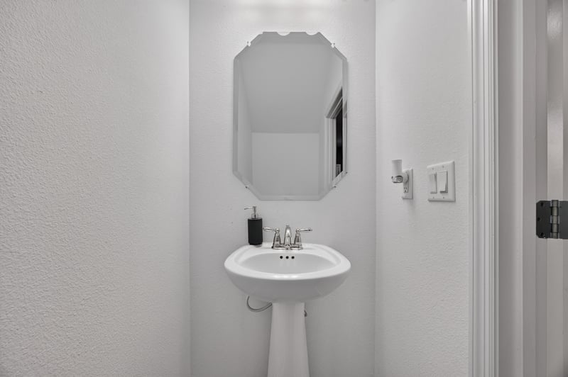 Half bathroom with pedestal sink and light switch at 339 Anthony Dr, Jacksonville, FL