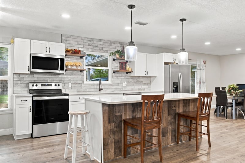 Kitchen island with bar seating and range at 357 Dillon Dr, Orange Park, FL