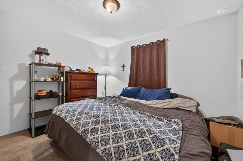 Secondary bedroom with bed and dresser at 518 Matecumbe Ct, Macclenny, FL