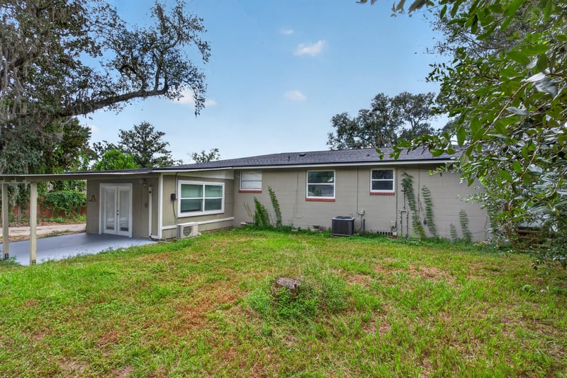 Side yard view with shed and open lawn at 217 Baisden Rd, Jacksonville, FL 32218