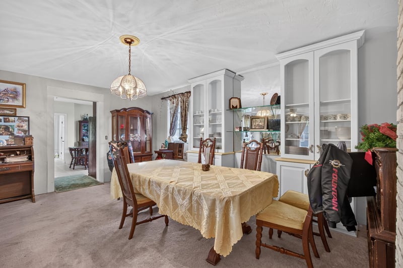 Dining room with built-in cabinetry and chandelier at 1173 US-17, Satsuma, FL 32189