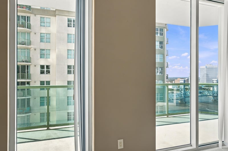Living space with balcony doors and skyline view, photographed by Megapixeler on Riverplace Blvd, Jacksonville