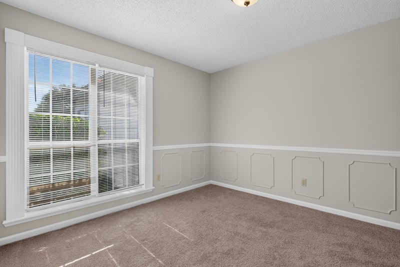 Dining room with window and chair-rail trim at 400 Ashcroft Landing Dr, Jacksonville, FL 32225