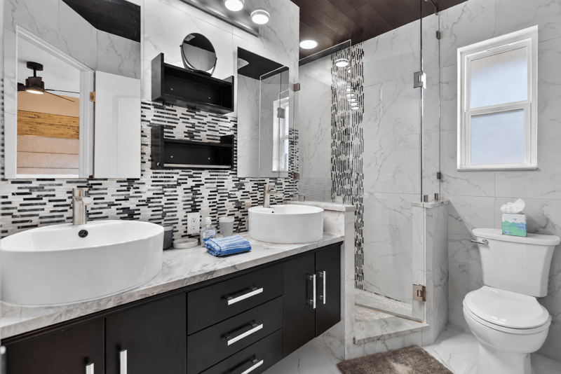 Bathroom with vessel sinks and glass shower at 1525 8th St N, Jacksonville Beach, FL
