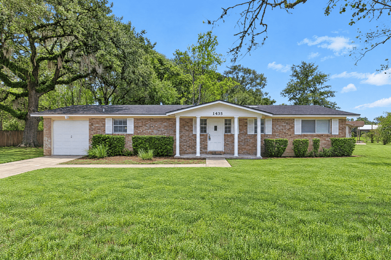 Front exterior with wide lawn and brick ranch facade at 1435 Undine Ave, Jacksonville, FL