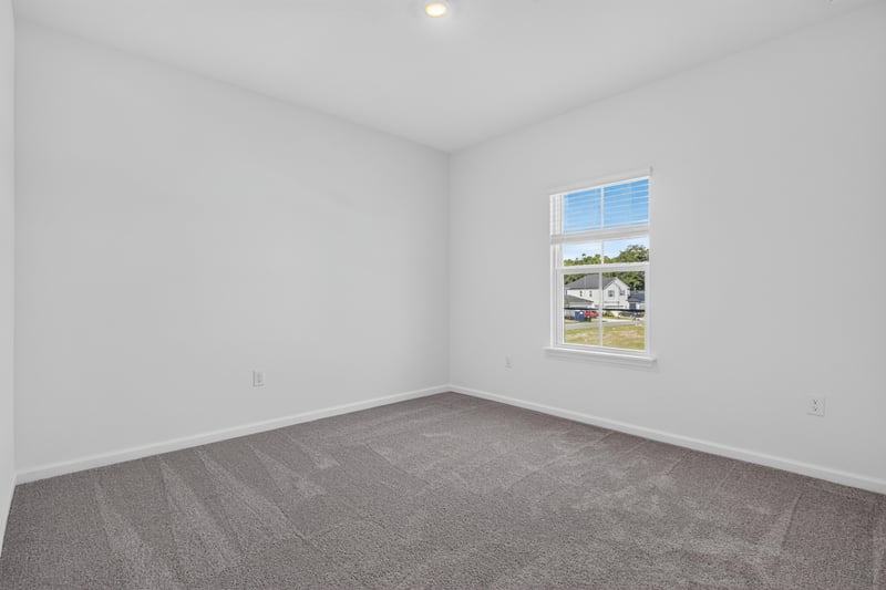 Empty carpeted bedroom corner at 269 Bluegrass Wy, St. Augustine, FL 32092