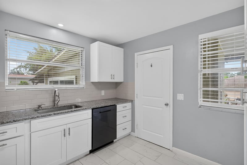 Kitchen with granite counters and tile backsplash at 217 Baisden Rd, Jacksonville, FL 32218