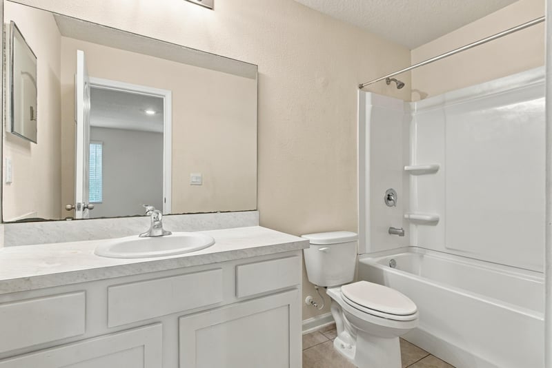 Bathroom with vanity, tub-shower, and toilet at 9555 Star Dr, Jacksonville, FL 32256