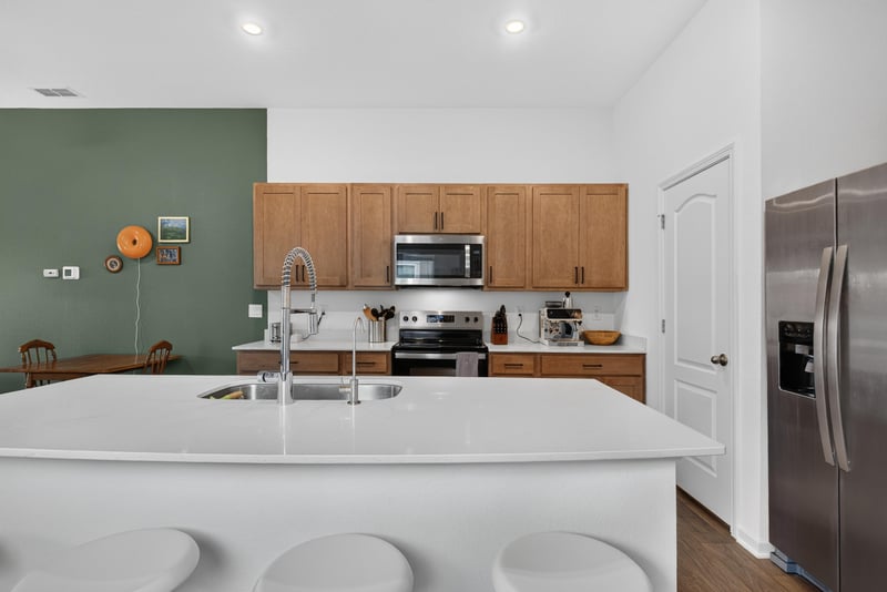 Kitchen island and stainless refrigerator at 4276 Quaking St, Jacksonville, FL 32218