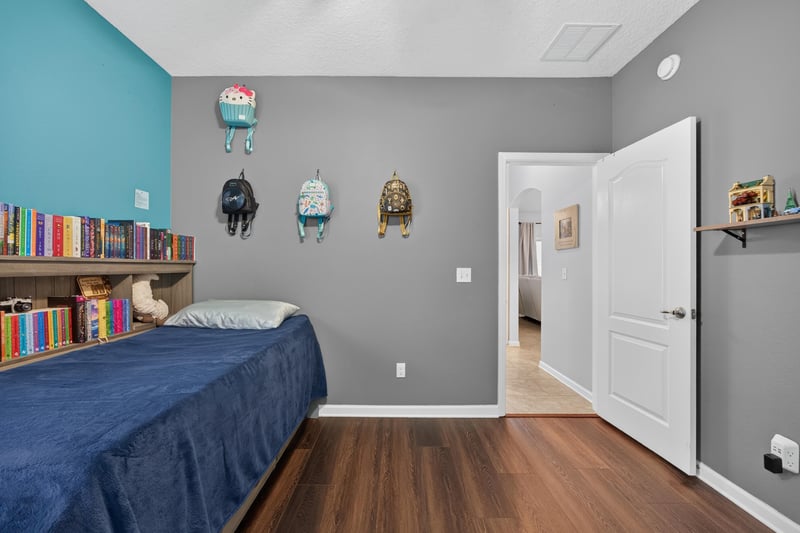 Bedroom with teal accent wall and bookshelf at 538 Porta Rosa Circle, St. Augustine, FL 32092