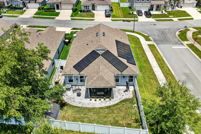 Aerial view of the backyard and solar panel roof at 10066 Andean Fox Dr, Jacksonville, FL 32222
